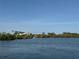 Scenic waterfront view with channel markers, mangroves, and homes in the distance under a clear blue sky at 519 Bayview Ave, Osprey, FL 34229