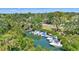 Waterfront view with boats docked among lush greenery, showing dock access at 519 Bayview Ave, Osprey, FL 34229