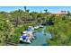 Waterfront view of boats docked along lush greenery with a home in the background at 519 Bayview Ave, Osprey, FL 34229