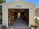 This workshop features work benches, plywood walls, and a 'Hangar' sign above the doorway at 519 Bayview Ave, Osprey, FL 34229