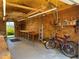 This workshop features work benches, plywood walls, bicycles, and a rear door at 519 Bayview Ave, Osprey, FL 34229