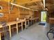 This workshop features work benches, plywood walls, and a rear door at 519 Bayview Ave, Osprey, FL 34229