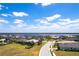 Aerial view showcasing a beautiful waterfront community with well-manicured lawns and stunning water views at 5502 Tidewater Preserve Blvd, Bradenton, FL 34208
