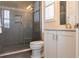 Modern bathroom features a glass-enclosed shower and a vanity with white cabinetry at 5502 Tidewater Preserve Blvd, Bradenton, FL 34208