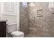 Modern bathroom with glass shower featuring tile surround, bench, and shower niche at 5502 Tidewater Preserve Blvd, Bradenton, FL 34208