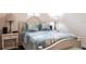 Inviting bedroom with light blue quilt, two side tables and lamps at 5502 Tidewater Preserve Blvd, Bradenton, FL 34208