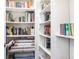 Well-organized closet shelves filled with books and other items at 5502 Tidewater Preserve Blvd, Bradenton, FL 34208