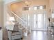 Bright foyer with tile floors, a staircase, and a decorative front door with sidelights at 5502 Tidewater Preserve Blvd, Bradenton, FL 34208
