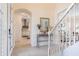 Welcoming foyer with a staircase, console table, and a view into the kitchen and living areas at 5502 Tidewater Preserve Blvd, Bradenton, FL 34208