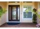 Stylish front door with decorative glass and side window, enhanced by well-manicured plants at 5502 Tidewater Preserve Blvd, Bradenton, FL 34208
