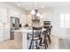 Modern kitchen with a large island, stainless steel appliances, and white cabinetry at 5502 Tidewater Preserve Blvd, Bradenton, FL 34208