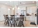 Modern kitchen with a large island, stainless steel appliances, and white cabinetry at 5502 Tidewater Preserve Blvd, Bradenton, FL 34208