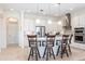 Modern kitchen with a large island, stainless steel appliances, and white cabinetry at 5502 Tidewater Preserve Blvd, Bradenton, FL 34208