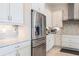 Contemporary kitchen featuring stainless steel refrigerator and appliances, plus stylish tiled backsplash at 5502 Tidewater Preserve Blvd, Bradenton, FL 34208