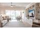 Spacious living room with built-in shelving, a ceiling fan, and sliding glass doors to the lanai at 5502 Tidewater Preserve Blvd, Bradenton, FL 34208