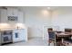 Living room wet bar with a wine rack, mini fridge, and adjacent dining area at 5502 Tidewater Preserve Blvd, Bradenton, FL 34208