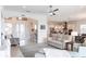 Open-concept living room with tile flooring, a ceiling fan, and views into the dining and kitchen areas at 5502 Tidewater Preserve Blvd, Bradenton, FL 34208