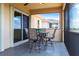 A covered patio features a dining table with seating for four, perfect for enjoying outdoor meals at 5502 Tidewater Preserve Blvd, Bradenton, FL 34208