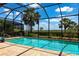 Sparkling pool with a screened enclosure and lush landscaping offers a private and refreshing outdoor retreat at 5502 Tidewater Preserve Blvd, Bradenton, FL 34208