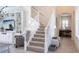 Bright, open staircase with white banisters leading to upper levels at 5502 Tidewater Preserve Blvd, Bradenton, FL 34208