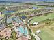 Aerial view of the resort-style pool, tennis courts, and golf course showcasing community lifestyle at 5528 Palmer Cir # 204, Lakewood Ranch, FL 34211