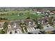 View of condo community highlighting attached garages, lush landscaping and golf course views at 5528 Palmer Cir # 204, Lakewood Ranch, FL 34211