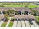 Aerial view of multi-unit home with garages, landscaping and golf course view at 5528 Palmer Cir # 204, Lakewood Ranch, FL 34211
