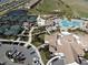 Stunning aerial view of community amenities, including a pool, tennis courts, and clubhouse with parking at 5528 Palmer Cir # 204, Lakewood Ranch, FL 34211