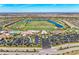 Wide aerial shot of the community with a golf course, lake, tennis courts, and clubhouse with parking at 5528 Palmer Cir # 204, Lakewood Ranch, FL 34211