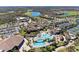 Expansive aerial view showcases the community pool, tennis courts, clubhouse, and surrounding landscaping at 5528 Palmer Cir # 204, Lakewood Ranch, FL 34211