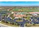 Impressive aerial perspective of the clubhouse, pool, tennis courts, and community golf course at 5528 Palmer Cir # 204, Lakewood Ranch, FL 34211