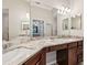 Bathroom features double sinks, granite countertops, and vanity space with large mirror at 5528 Palmer Cir # 204, Lakewood Ranch, FL 34211