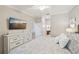 A spacious bedroom features a tv, dresser and en suite bathroom at 5528 Palmer Cir # 204, Lakewood Ranch, FL 34211