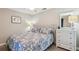 Bedroom with plush bed, dresser, and coordinated lamps, artwork and ceiling fan at 5528 Palmer Cir # 204, Lakewood Ranch, FL 34211