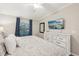 This bedroom offers natural light and a large dresser with decoratively framed mirror at 5528 Palmer Cir # 204, Lakewood Ranch, FL 34211