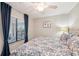 Comfortable bedroom with modern ceiling fan, and view of the screened lanai at 5528 Palmer Cir # 204, Lakewood Ranch, FL 34211