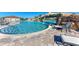 Resort-style pool with a waterfall feature, surrounded by lounge chairs for ultimate relaxation at 5528 Palmer Cir # 204, Lakewood Ranch, FL 34211