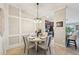 Cozy dining area featuring elegant wainscoting and an adjacent kitchen with stainless appliances at 5528 Palmer Cir # 204, Lakewood Ranch, FL 34211