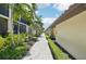 Walkway view of condos featuring lush landscaping, manicured hedges, and well-maintained pathways at 5528 Palmer Cir # 204, Lakewood Ranch, FL 34211