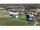 Scenic aerial view of the community golf course and clubhouse, surrounded by lush greenery and homes at 5528 Palmer Cir # 204, Lakewood Ranch, FL 34211