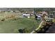 Aerial view of golf course and clubhouse surrounded by mature trees at 5528 Palmer Cir # 204, Lakewood Ranch, FL 34211