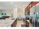 Modern kitchen with granite countertops, stainless appliances, and open layout to living area at 5528 Palmer Cir # 204, Lakewood Ranch, FL 34211