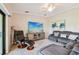 Comfortable living room with sectional seating, modern entertainment center, and a ceiling fan at 5528 Palmer Cir # 204, Lakewood Ranch, FL 34211