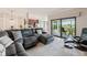 Spacious living room with plush sectional, recliner, and access to outdoor patio at 5528 Palmer Cir # 204, Lakewood Ranch, FL 34211