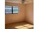 Bedroom featuring a large window and ceiling fan at 5970 80Th N St # 101, St Petersburg, FL 33709