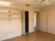 Bedroom with decorative shelving unit and access to the en suite at 5970 80Th N St # 101, St Petersburg, FL 33709