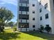 Low-rise condo building featuring white balconies and green lawn at 5970 80Th N St # 101, St Petersburg, FL 33709