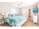 Bright bedroom with a queen bed, wood flooring, and a view of an adjacent bathroom at 6009 Lords Ave, Sarasota, FL 34231