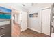 Cozy bedroom with light gray walls, wood floors, and beach-themed decor creating a relaxing ambiance at 6009 Lords Ave, Sarasota, FL 34231