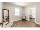 Cozy bedroom with neutral walls and wood flooring, featuring stylish decor and ample natural light at 6009 Lords Ave, Sarasota, FL 34231